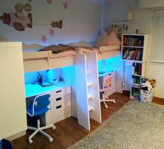 two children's bunk beds with desks and bookshelves in a room