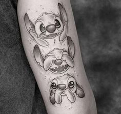 a tattoo with stitching on the arm and an image of two dogs in different positions