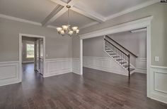 an empty living room with hard wood floors and white trim on the walls is shown