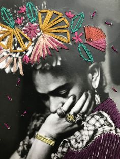 a black and white photo of a woman with flowers on her head, holding her hand to her face