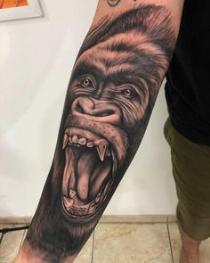 a man's arm with an animal tattoo on it, and the image of a gorilla