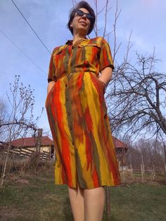 "Vintage 80s high waisted shirtdress. Colorful short sleeve buttoned up midi dress. Has two front pockets on the bodice and two side pockets. Elastic waist. Bronze colour metal buttons. Marked as USA 10 size. From shoulder to shoulder 20\" 51cm Bust 40\" 102cm Waist 38\" 71cm Hips 40\" 102cm Sleeve length 9\" 23cm Length 47\" 119cm In good vintage condition" Summer Multicolor Midi Dress With Pockets, Multicolor Short Sleeve Shirt Dress For Daywear, Collared Midi Dress With Pockets For Summer, Fitted Multicolor Short Sleeve Shirt Dress, Fitted Multicolor Midi Shirt Dress, Fitted Multicolor Midi Length Shirt Dress, Fitted Summer Shirt Dress With Pockets, Fall Short Sleeve Midi Dress With Pockets, Fall Midi Dress With Pockets And Short Sleeves