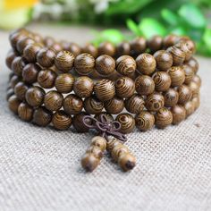 High quality Buddha beaded necklace made from different finishes of scented wood.  Comes in 108 of 8 mm beads. Free gift bag comes with purchase. Natural Wood Beaded Bracelets With Round Beads, Natural Wood Beaded Bracelets, Brown Wooden Beaded Bracelets With 8mm Beads, Brown Wooden Beaded Bracelets With Round Beads, Brown Wood Beaded Bracelets With Round Beads, Brown Wooden Beaded Bracelets, Brown Wooden Beaded Bracelets As A Gift, Brown Wooden Beaded Bracelet As A Gift, Gift Beaded Bracelets With Round Beads