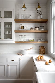 the kitchen is clean and ready to be used for cooking or baking, with all white cabinets