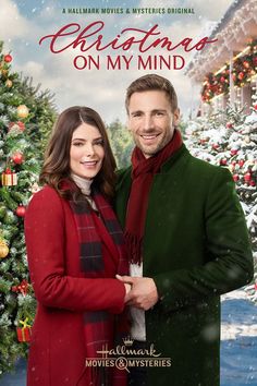 a man and woman standing next to each other in front of a christmas tree with the words on my mind