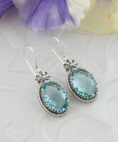 Silver Topaz Earrings With Gemstone, Silver Topaz Gemstone Earrings, Silver Blue Topaz Earrings Fine Jewelry, Elegant Blue Sterling Silver Earrings, Elegant Blue Topaz Nickel-free Earrings, Elegant Nickel-free Blue Topaz Earrings, Blue Topaz Earrings As A Gift, Oval Topaz Earrings As Gift, Oval Topaz Earrings For Gift