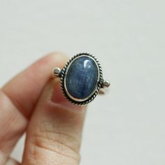 We are very excited about the look and feel of our new Deep Blue Kyanite Lasso Ring! This Boho Blue Kyanite Ring looks and feels great - you won't want to take it off! Perfectly balanced with a healthy sized 10X14mm Blue Kyanite stone, .925 Sterling silver accents and half-round shank - super comfortable and easy to wear. This ring's all sterling silver details are unique and truly set off the stone! You might want to make room on your hand -- you're going to want to wear this Blue Kyanite State Everyday Sapphire Ring Jewelry, Sapphire Cabochon Rings For Gifts, Everyday Sapphire Ring, Everyday Blue Sapphire Ring, Blue Rings With Large Stone For Healing, Handmade Oval Sapphire Rings, Blue Untreated Oval Rings, Untreated Oval Sapphire Ring For Gift, Untreated Oval Sapphire Ring As Gift