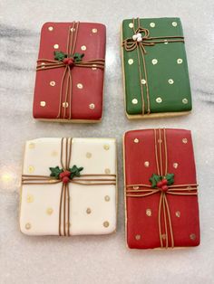 four decorated cookies sitting on top of a counter