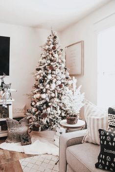 a living room with a christmas tree in the corner