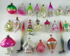 a collection of glass christmas ornaments and pens