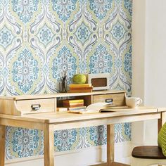 an advertisement for a wallpaper store featuring blue and white tiles on the walls, with a wooden desk in front of it