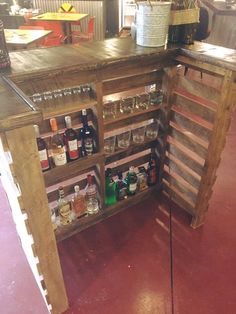 a wooden bar with lots of bottles on it