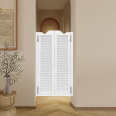 an open door leading into a room with white shutters on the doors and a plant in a vase next to it