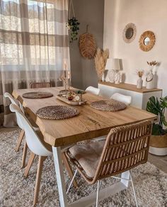 a dining room table and chairs in front of a window