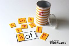 a stack of orange and white cups sitting next to each other on top of a table