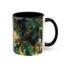 a black and white coffee mug filled with lots of green marbled material on it