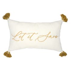 a white and gold pillow with the words let it snow written on it's side