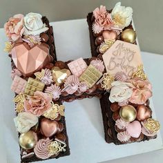 the letter h is decorated with chocolate and flowers