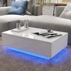 a white coffee table with blue lights on it