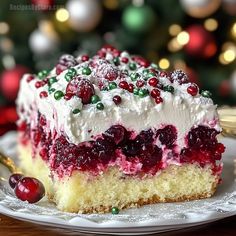 a piece of cake with white frosting and cranberry toppings on a plate