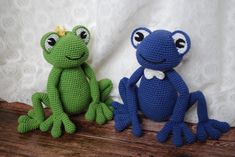 two crocheted frogs sitting next to each other