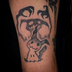 a close up of a person's arm with a tattoo on it and an image of pikachu