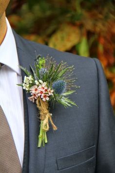 a man in a suit with a boutonniere on his lapel