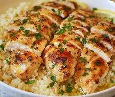 chicken and rice in a white bowl with garnished with parsley on top