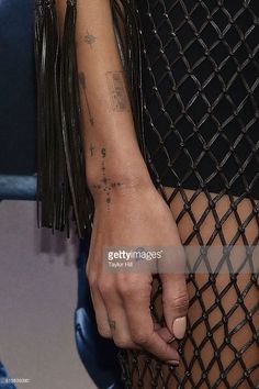 a woman's arm with tattoos on it is seen in this undrecognized photo