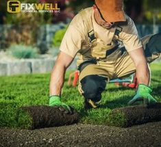 a man is working in the grass with some tools