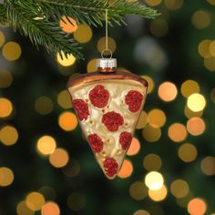 a christmas ornament hanging from a tree decorated with pizza slices and pepperoni