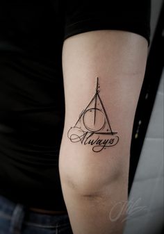 a harry potter tattoo on the right arm and shoulder, with the word always written in cursive writing