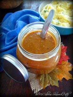 a jar filled with sauce sitting on top of a table