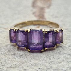 A beautiful amethyst ring, small and cute, this classic piece always impresses with its deep purple colour 💜. UK Ring Size: N US Ring Size: 6.75 Weight: 2.4 grams Number of Stones: 5 Stones  Hallmarked 9ct Gold Emerald Cut Hallmarked Amethyst Ring, Amethyst Ring Gold, Gold Vintage Ring, Gold Ring For Women, Gold Amethyst Ring, Deep Purple Color, Purple Colour, Crystal Ring, Gold Crystal