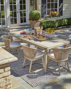 an outdoor dining table and chairs on a patio