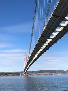 the underside of a large bridge over water