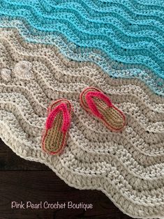 crocheted beach blanket with slippers on it