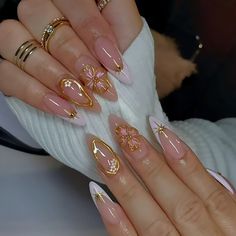 a woman's hands with pink and gold nails