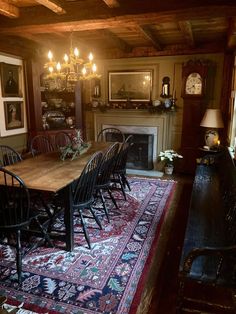 a dining room table with chairs and a rug on the floor in front of it