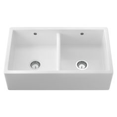 a white double bowl sink with two faucets on the front and one side