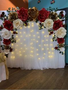 the backdrop is decorated with red, white and gold flowers