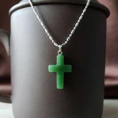 Genuine nephrite jade cross pendant from British Columbia, Canada. The color is a beautiful translucent green. Comes with a plated jump ring. Jade brings harmony and contentment to the wearer. In Asian cultures, Jade is revered as the good luck stone which can bring happiness, wealth, and friendship. Option to purchase heavy solid 925 sterling silver chain necklace. 22mm x 14mm Spiritual Jade Jewelry Gift, Spiritual Jade Jewelry For Gifts, Green Cross Pendant Necklace As Gift, Green Cross Necklace For Gift, Spiritual Jade Necklace Gift, Green Spiritual Cross Pendant Jewelry, Jade Pendant Necklace As A Gift, Spiritual Jade Crystal Necklace Gift, Jade Crystal Pendant Necklace As A Gift