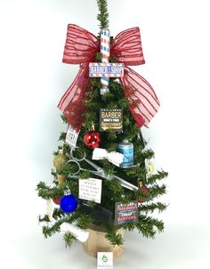 a small christmas tree decorated with items from barbershop and other stores on it