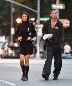 a man and woman walking down the street