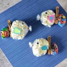 rice krispy kreme fish treats are on a blue mat with pegs