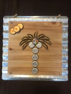 a wooden plaque with fruit and palm tree on it