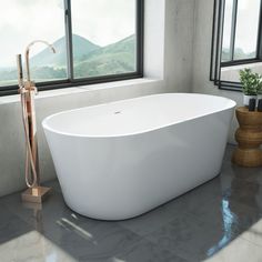 a large white bath tub sitting next to a window