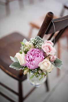 a bouquet of flowers sitting on top of a wooden chair