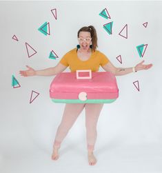 a woman is holding an inflatable object with both hands and her mouth wide open