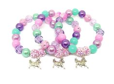 These adorable stretchy bracelets are the perfect favor for your little one's horse themed party! Each bracelet features a Tibetan silver horse charm, resin rhinestone beads and a beautiful assortment of pink, light purple, purple and aqua 10mm acrylic beads strung with durable stretch floss cord. Each bracelet will arrive individually packaged in an organza bag. Please select the amount of bracelets and the size needed from the drop down menus. Exact shade and bead styles will vary. Silver Novelty Charm Bracelet For Birthday, Novelty Beaded Jewelry For Birthdays, Adjustable Purple Charm Bracelet For Birthday, Pink Bracelet For Party Favors, Silver Novelty Bracelets For Party, Silver Beaded Stretch Bracelet For Birthday, Playful Silver Bracelets For Birthday, Novelty Pink Jewelry With Round Beads, Adjustable Purple Stretch Bracelet For Birthday